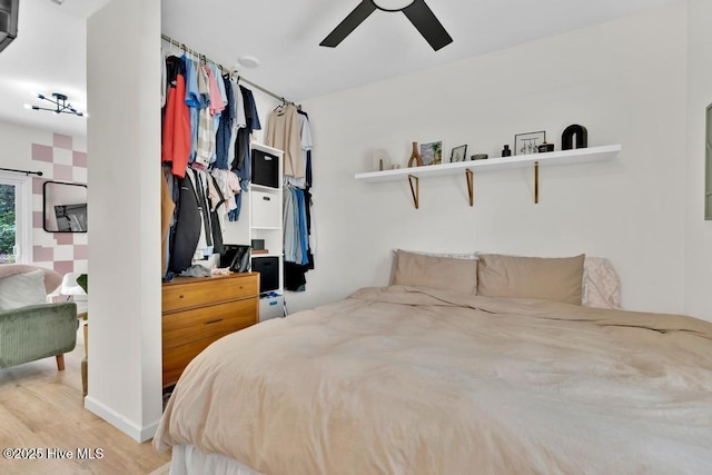 334 NE 48th St, Oak Island, NC 28465 - bedroom with light wood-style floors and ceiling fan