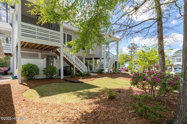 334 NE 48th St, Oak Island, NC 28465 - view of green lawn featuring stairs