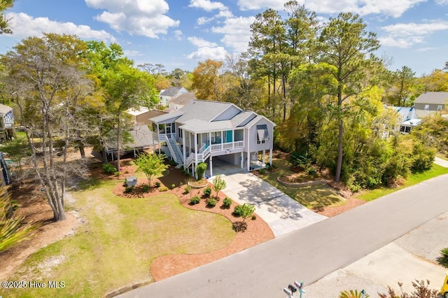 334 NE 48th St, Oak Island, NC 28465 - view of front of house with driveway, a carport, and stairs