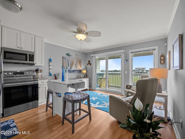 650 Cedar Point Blvd Unit B14, Cedar Point, NC 28584 - kitchen with white cabinetry, appliances with stainless steel finishes, a ceiling fan, and light wood finished floors