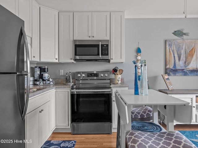 650 Cedar Point Blvd Unit B14, Cedar Point, NC 28584 - kitchen featuring light wood-style flooring, appliances with stainless steel finishes, light countertops, and white cabinets