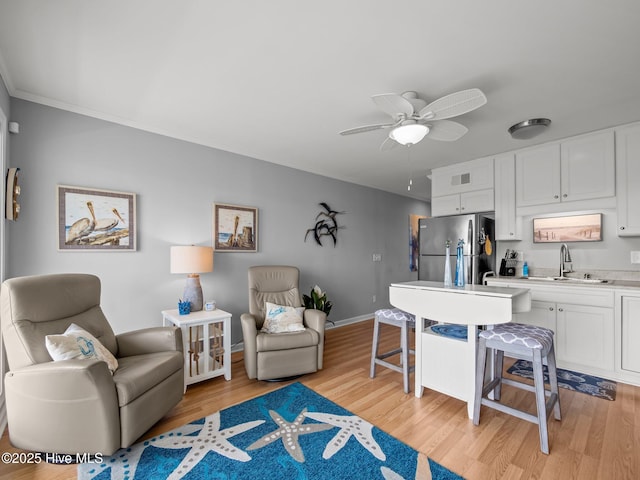 650 Cedar Point Blvd Unit B14, Cedar Point, NC 28584 - kitchen featuring white cabinets, open floor plan, a sink, and freestanding refrigerator
