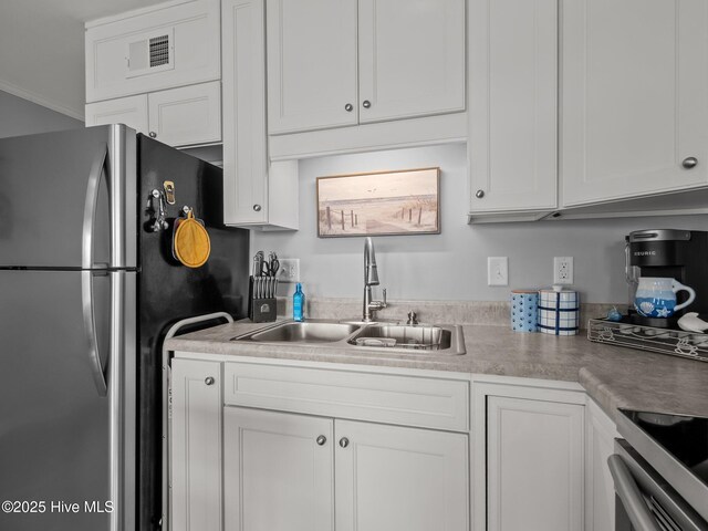 650 Cedar Point Blvd Unit B14, Cedar Point, NC 28584 - kitchen featuring light countertops, white cabinetry, visible vents, stainless steel appliances, and a sink