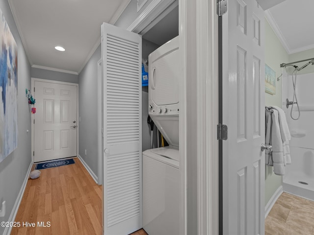 650 Cedar Point Blvd Unit B14, Cedar Point, NC 28584 - washroom with baseboards, stacked washer / dryer, laundry area, and ornamental molding