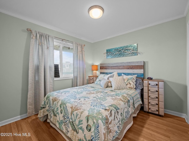 650 Cedar Point Blvd Unit B14, Cedar Point, NC 28584 - bedroom featuring ornamental molding, baseboards, and wood finished floors