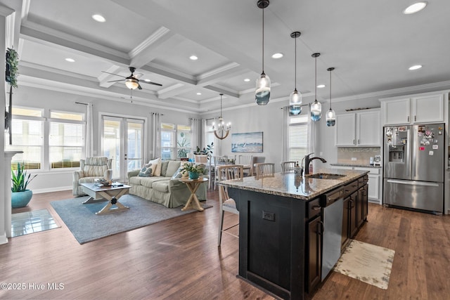 kitchen with plenty of natural light, a breakfast bar area, stainless steel appliances, and a sink