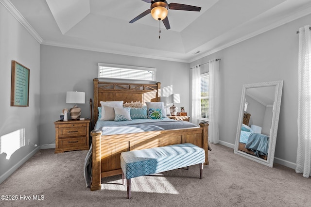 bedroom featuring crown molding, ceiling fan, carpet, baseboards, and a raised ceiling