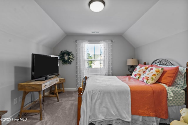 bedroom with vaulted ceiling, carpet floors, and baseboards