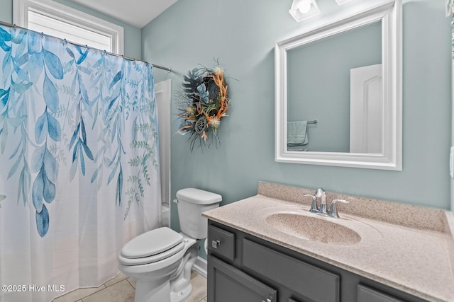 full bathroom with vanity, tile patterned flooring, and toilet