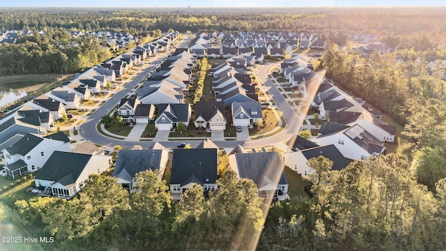 birds eye view of property with a residential view and a wooded view