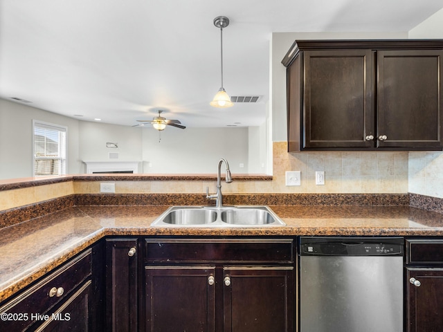 kitchen with stainless steel dishwasher, a sink, a ceiling fan, and dark countertops