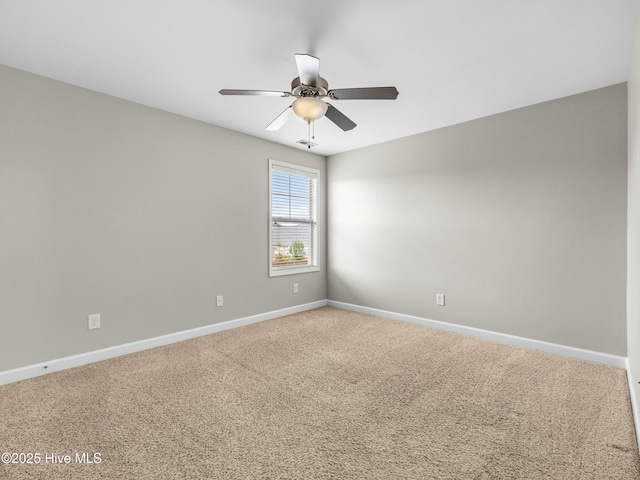 spare room with carpet floors, baseboards, and a ceiling fan
