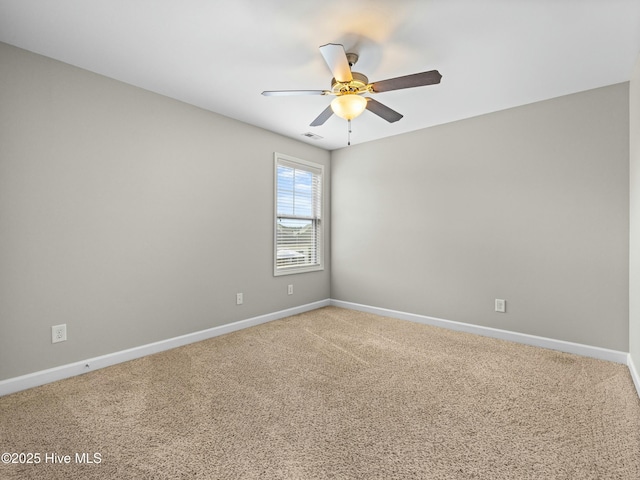 empty room featuring light colored carpet, ceiling fan, baseboards, and visible vents