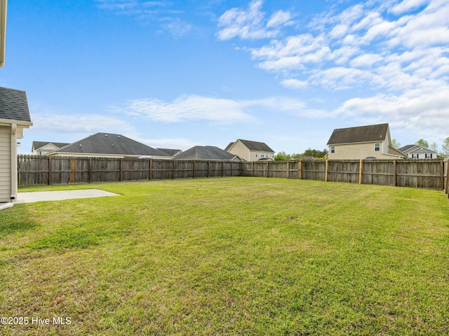 view of yard featuring a patio area and a fenced backyard