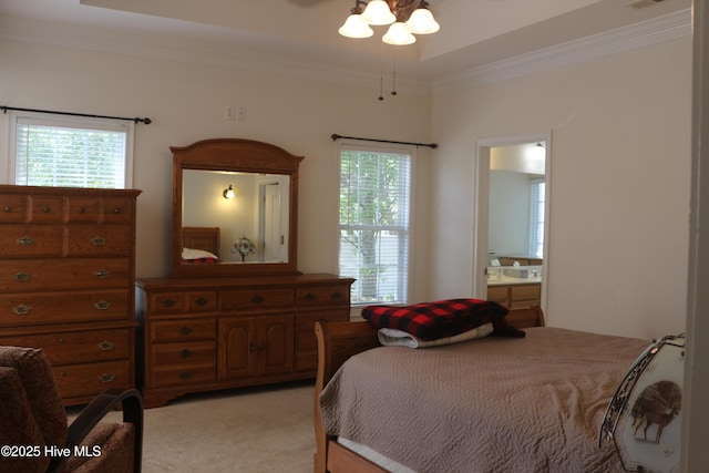 bedroom featuring ornamental molding, light carpet, ensuite bath, and multiple windows