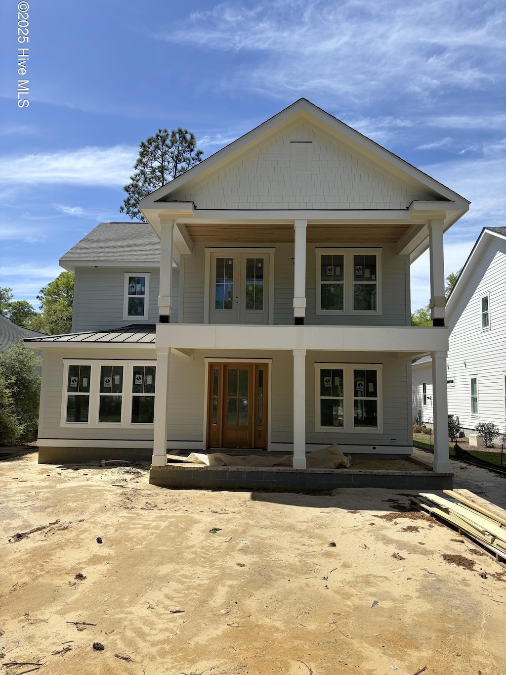 305 Jenoa Dr, Castle Hayne, NC 28429 - rear view of property with covered porch, a standing seam roof, and metal roof