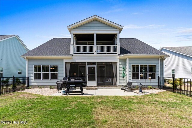 back of property with a sunroom, a yard, a fenced backyard, a patio, and a balcony