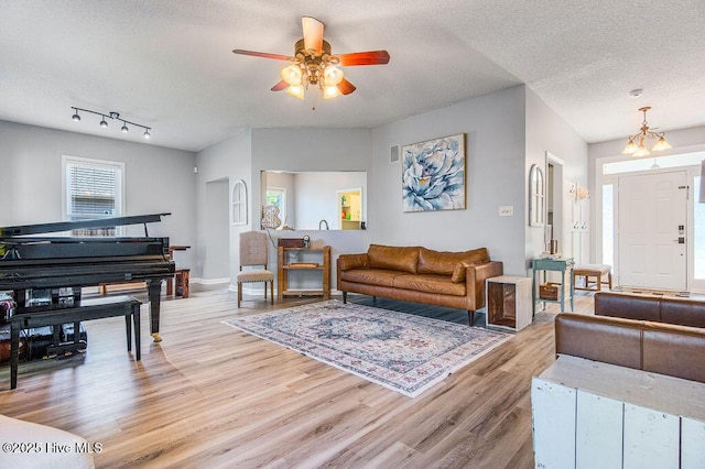 301 Softwood Ct, Jacksonville, NC 28540 - living room featuring baseboards, light wood-style flooring, a textured ceiling, and a ceiling fan
