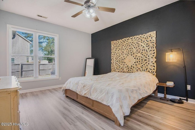 301 Softwood Ct, Jacksonville, NC 28540 - bedroom featuring wood finished floors, baseboards, a ceiling fan, and visible vents