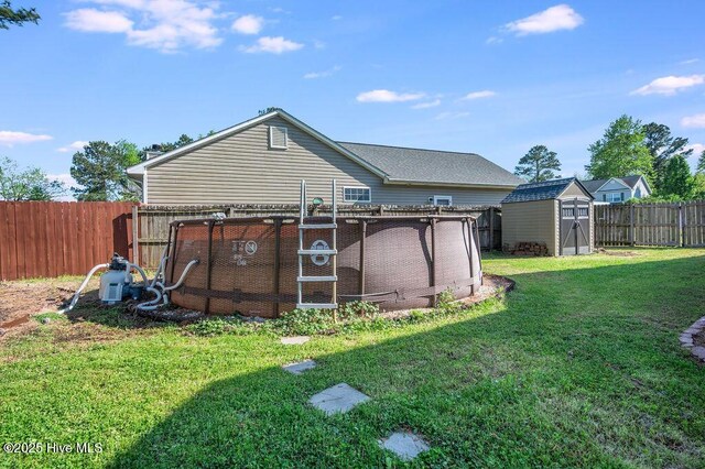 301 Softwood Ct, Jacksonville, NC 28540 - back of house featuring a lawn, a fenced backyard, an outbuilding, and a storage unit