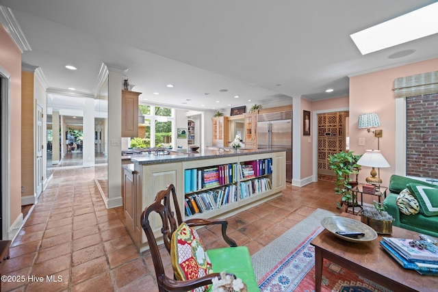living area featuring crown molding, baseboards, a skylight, and recessed lighting