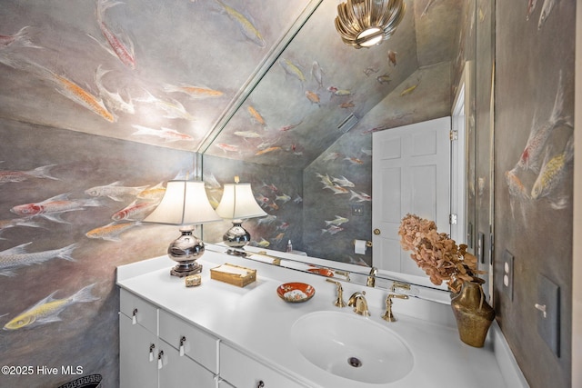 bathroom with vanity and vaulted ceiling