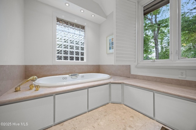 full bathroom featuring tile patterned flooring, a garden tub, recessed lighting, and a wealth of natural light