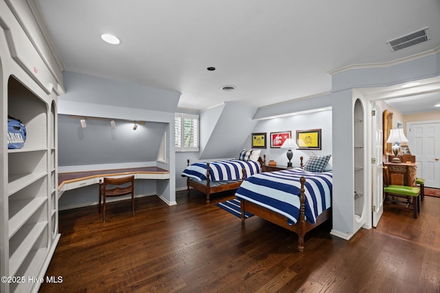 bedroom with baseboards, arched walkways, wood finished floors, and visible vents