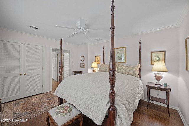 bedroom with visible vents, ornamental molding, and wood finished floors
