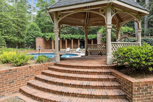 view of patio / terrace with a gazebo and an outdoor pool
