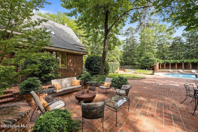 view of patio featuring outdoor lounge area, a fenced backyard, and an outdoor pool