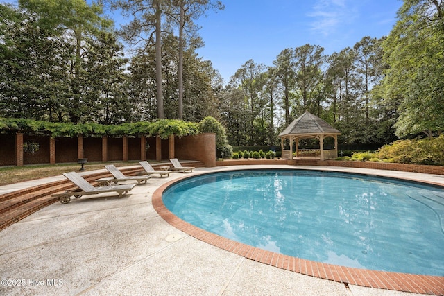 pool with a gazebo and a patio