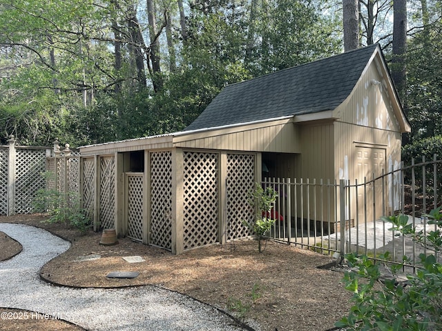 view of outbuilding featuring fence
