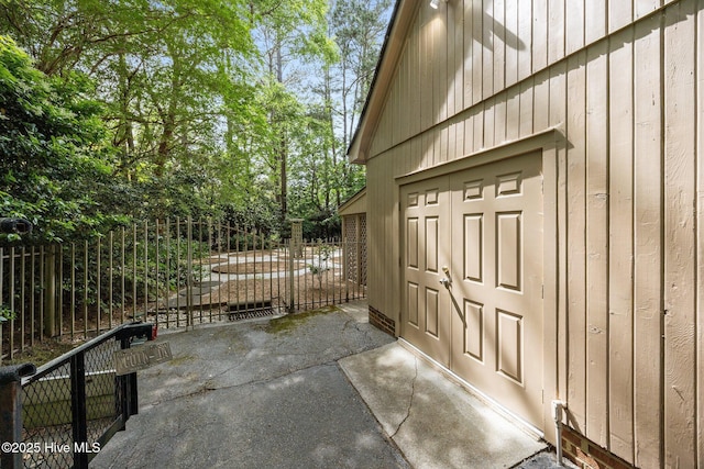 exterior space with board and batten siding and a gate