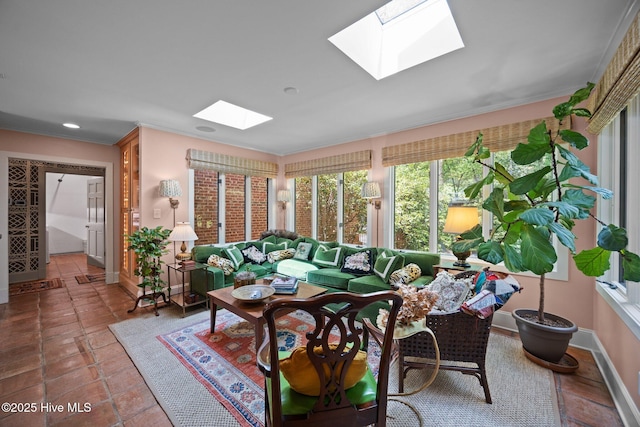 sunroom / solarium with baseboards, recessed lighting, crown molding, and a skylight