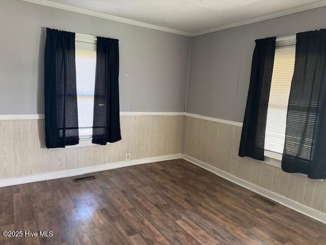 224 Millennium Rd # B, Aulander, NC 27805 - unfurnished room featuring crown molding, visible vents, wainscoting, and wood finished floors