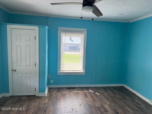 224 Millennium Rd # B, Aulander, NC 27805 - empty room featuring visible vents, baseboards, a ceiling fan, dark wood-style floors, and crown molding