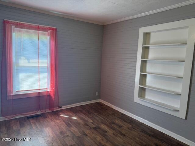 224 Millennium Rd # B, Aulander, NC 27805 - unfurnished room with built in features, baseboards, visible vents, ornamental molding, and wood finished floors