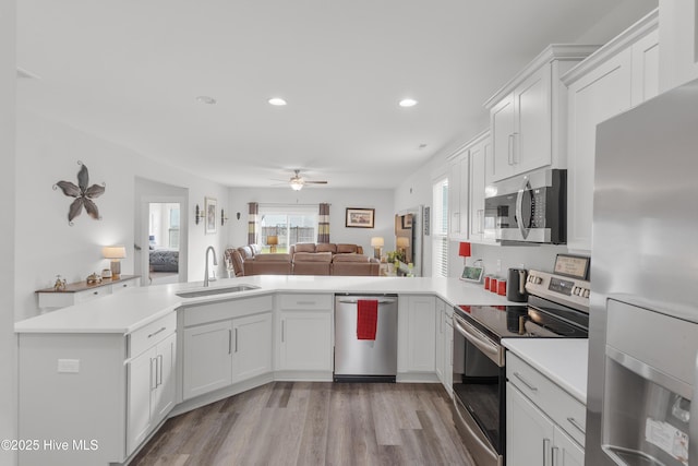 555 Heartwood Dr, Leland, NC 28479 - kitchen with light countertops, a ceiling fan, appliances with stainless steel finishes, light wood finished floors, and a sink