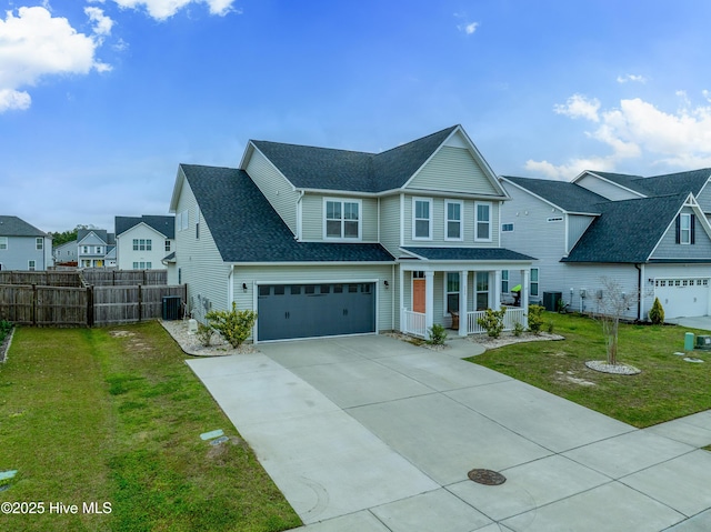 555 Heartwood Dr, Leland, NC 28479 - view of front of home with a porch, fence, driveway, and a front lawn