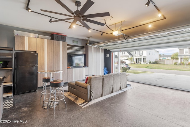 555 Heartwood Dr, Leland, NC 28479 - garage featuring freestanding refrigerator and a ceiling fan