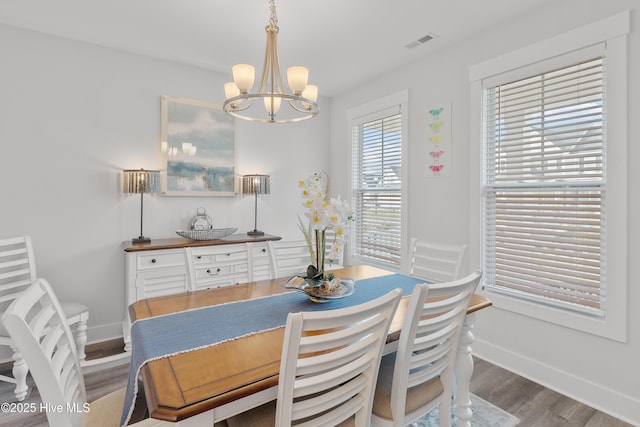 555 Heartwood Dr, Leland, NC 28479 - dining area with a notable chandelier, baseboards, visible vents, and wood finished floors