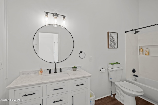 bathroom featuring vanity, baseboards, bathing tub / shower combination, toilet, and wood finished floors