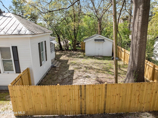 deck featuring an outbuilding, fence, and a shed
