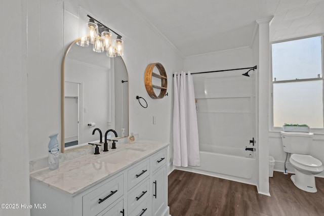 bathroom featuring ornamental molding, toilet, and wood finished floors