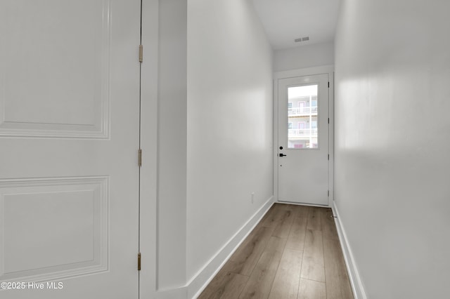 1205 Mackerel Ln Unit 2, Carolina Beach, NC 28428 - doorway to outside featuring wood finished floors, baseboards, and visible vents