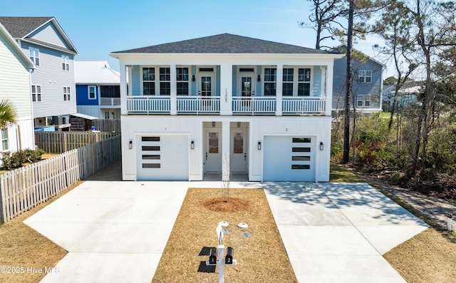 1205 Mackerel Ln Unit 2, Carolina Beach, NC 28428 - coastal home with board and batten siding, roof with shingles, fence, an attached garage, and driveway