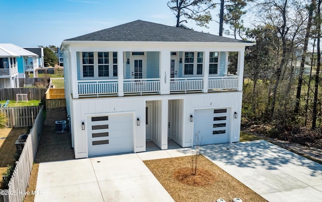 1205 Mackerel Ln Unit 2, Carolina Beach, NC 28428 - coastal home featuring an attached garage, a shingled roof, central air condition unit, and concrete driveway