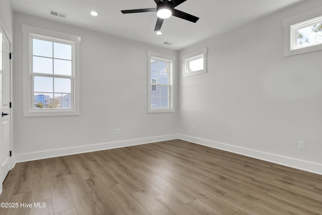 1205 Mackerel Ln Unit 2, Carolina Beach, NC 28428 - unfurnished room with wood finished floors, baseboards, a ceiling fan, and visible vents