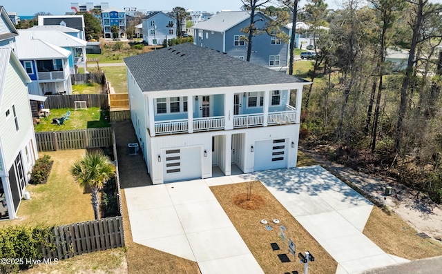 1205 Mackerel Ln Unit 2, Carolina Beach, NC 28428 - view of front of house with a garage, fence, a residential view, driveway, and roof with shingles